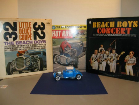 1961 original hot rod magazine cover, original Beach Boys albums, and limited edition 1932 Ford Little Deuce Coupe.
